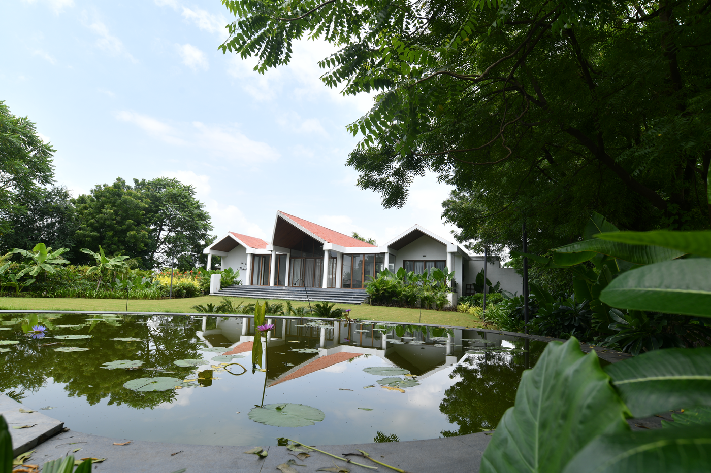 A SilverOak community reflected in a lily pond
